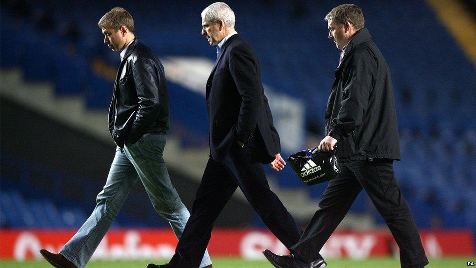 Chelsea owner Roman Abramovich (l) and Eugene Tenenbaum (c) walk across Stamford Bridge