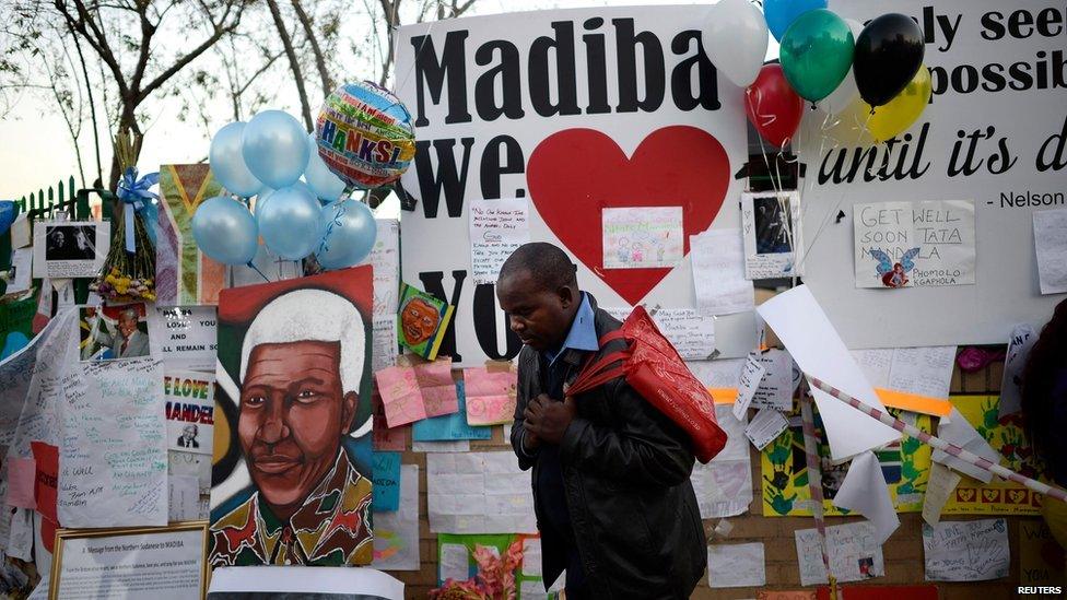 A man prays as he pays his respects outside the Medi-Clinic Heart Hospital, where ailing former South African President Nelson Mandela is being treated, in Pretoria on Thursday 27 June