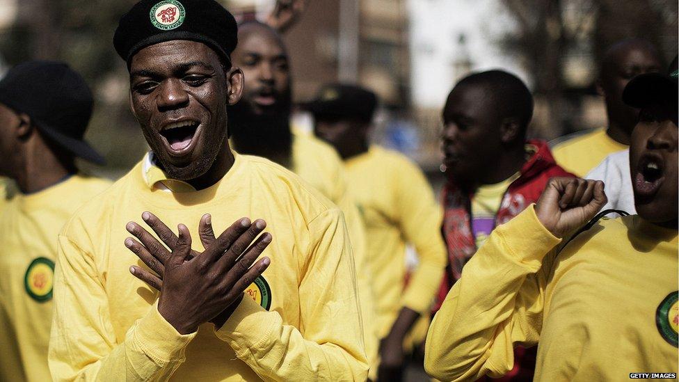 Members of the ruling African National Congress (ANC) party supporters dance outside the hospital (27 June 2013)