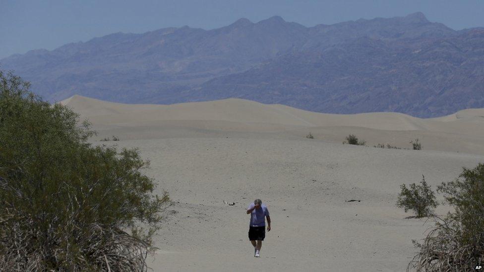 Man walks through Death Valley, California (28 June 2013)