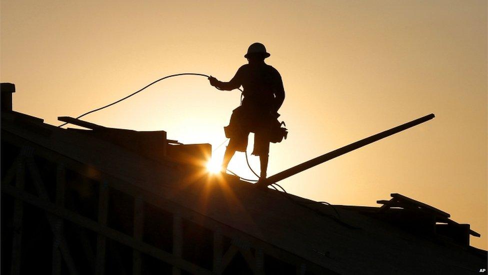 Construction worker carries out work at dawn in Queen Creek, Arizona (27 June 2013)