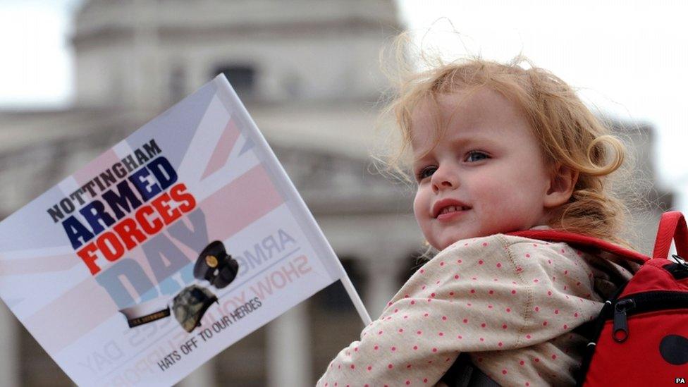 A child waves a flag at the Nottingham parade