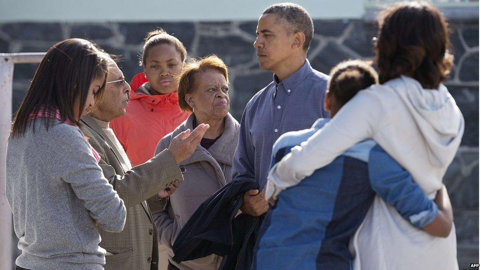 Ahmed Kathrada, a former prisoner with anti-apartheid activist Nelson Mandela, gives a tour of Robben Island to US President Barack Obama and his family.