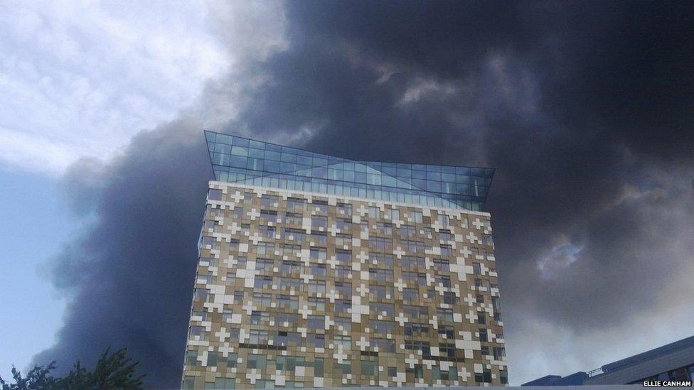 The Cube, Birmingham, surrounded by smoke. Photograph by Ellie Canham.