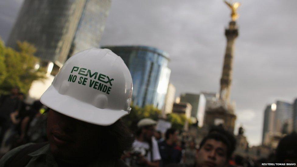 A demonstrator wears a helmet with a sticker that reads "Pemex is not for sale" during a protest against the privatisation of the state oil monopoly Pemex in Mexico City, 1 July