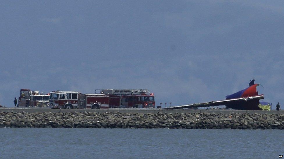 The tail of Asiana Flight 214 is seen after it crashed at San Francisco International Airport 6 July 2013.