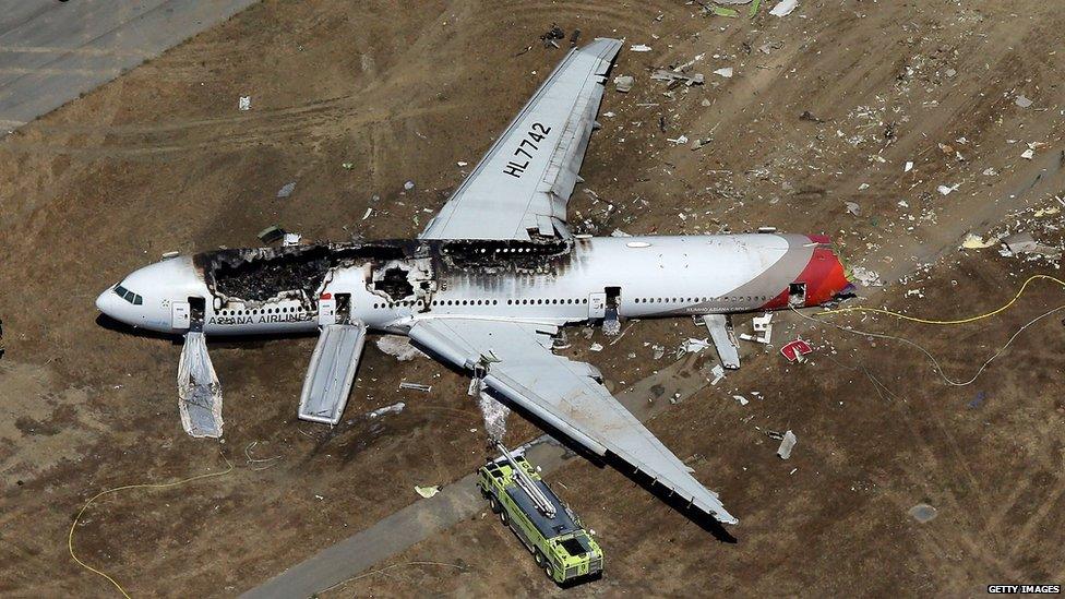 A Boeing 777 airplane lies burned on the runway after it crash landed at San Francisco International Airport on 6 July, 2013