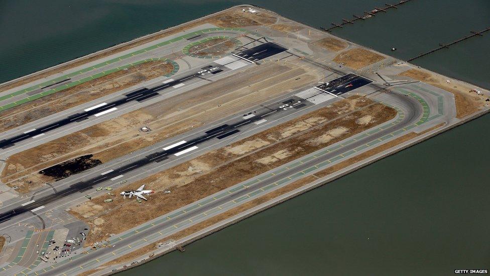 A Boeing 777 airplane lies burned on the runway after it crash landed at San Francisco International Airport on 6 July, 2013