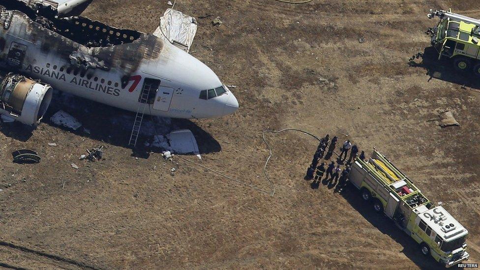 Fire fighters surround an Asiana Airlines Boeing 777 plane after it crashed while landing at San Francisco International Airporton 6 July, 2013.