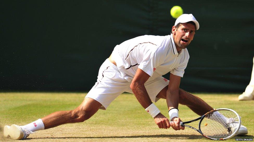 Novak Djokovic slips as he tries to retrieve an Andy Murray shot