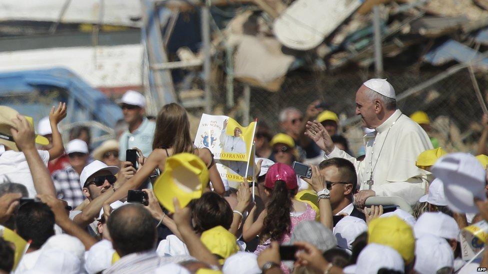 The Pope rides an open-topped car on Lampedusa