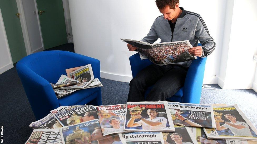 Andy Murray poses with newspapers