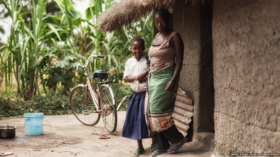 Sylvia and her mother outside their family home in rural Tanzania