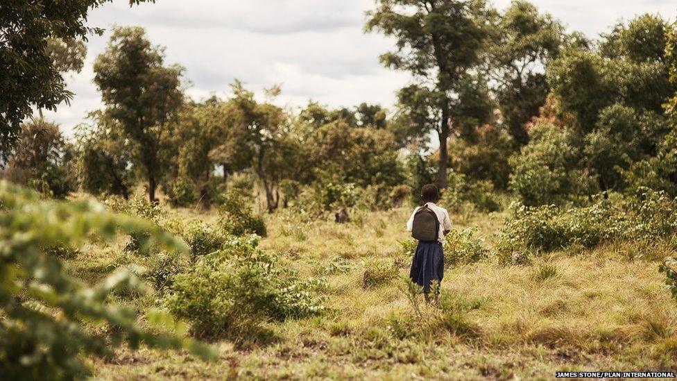 Tanzanian schoolgirl Sylvia walking through the bush