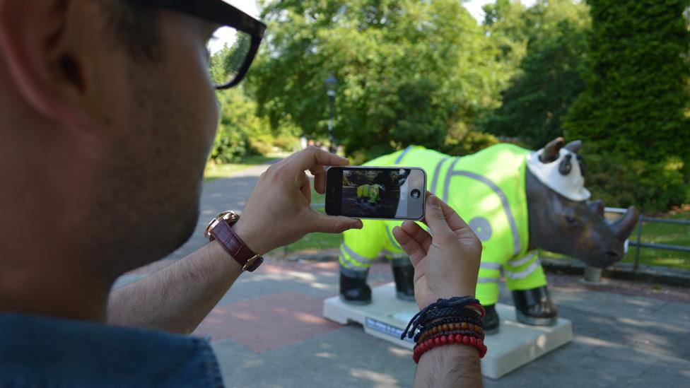 Rhino being photographed in park