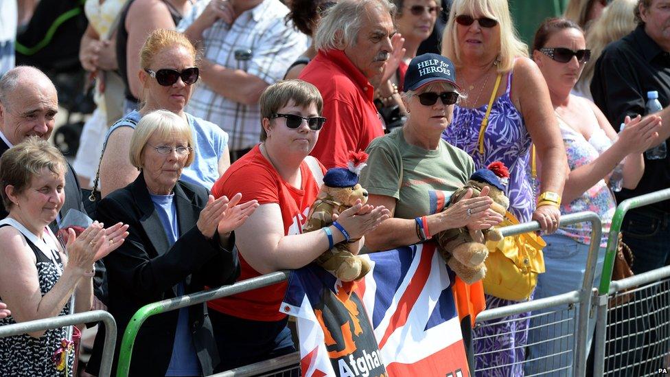 Crowds pay their respect as mourners arrive for the funeral service