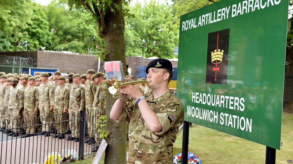 Bugler Dan Griffith plays the last post outside the main gate to Woolwich Barracks in south east London, in memory of Fusilier Lee Rigby, as his funeral takes place