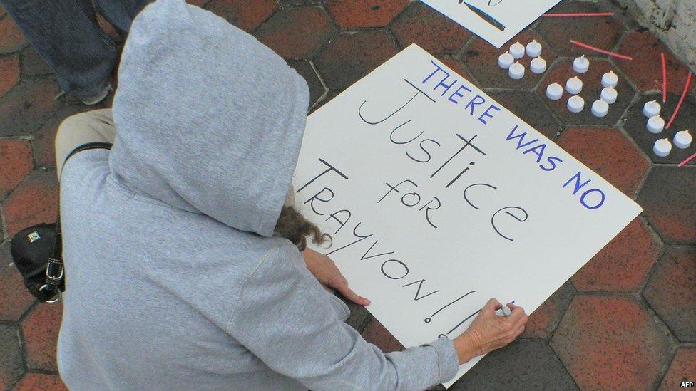 Protester JoAnn Vega in Miami puts finishing touches on a sign (14 July)