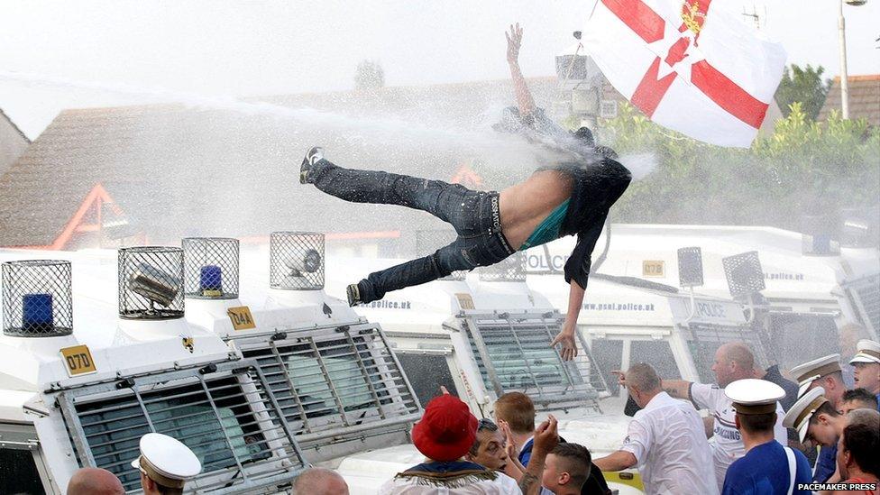 Protestor falling from roof