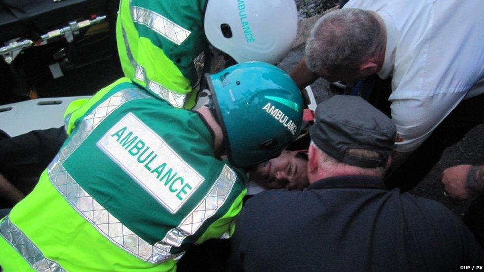 Nigel Dodds being treated by paramedics