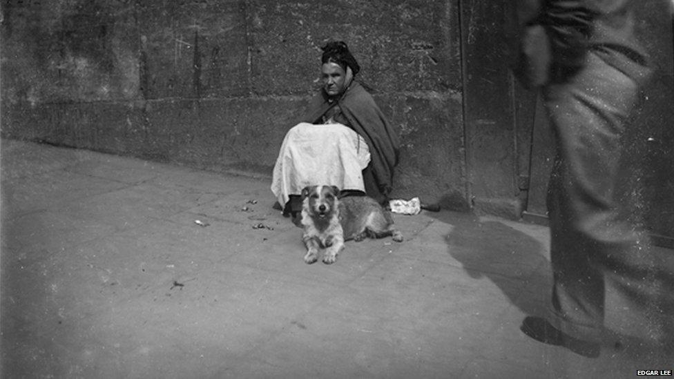 Man walks past a blind woman and her dog, Edgar Lee, c 1892