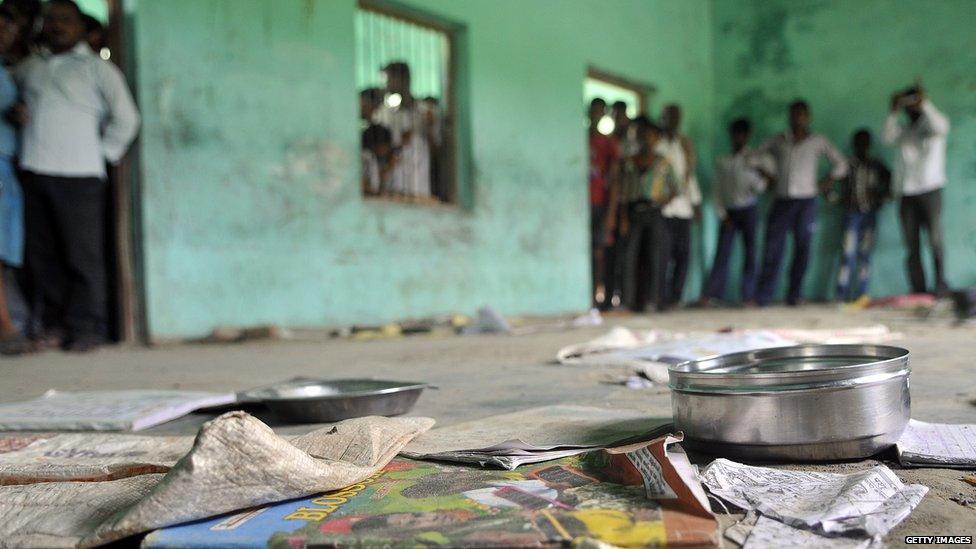 The scattered belongings of children who consumed a free midday meal in Dharma Sati village in the Saran district of Bihar state on 17 July 2013