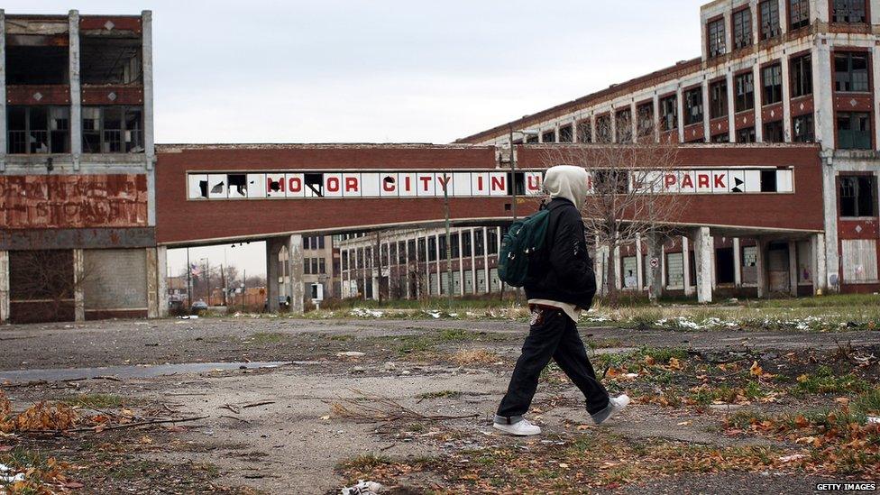 A person walks past the remains of the Packard Motor Car Company building in Detroit, November 2008