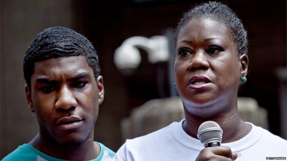 Trayvon Martins mother Sybrina Fulton speaks at a podium as Trayvon Martins brother Jahvaris Fulton (l) stands by during a rally honouring Trayvon Martin organized by the National Action Network outside One Police Plaza in Manhattan 20 July 2013 in New York City.