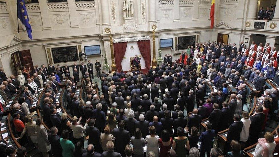 Philippe stands in front of members of parliament and the senate at the Palace of the Nation in Brussels, 21 July 2013