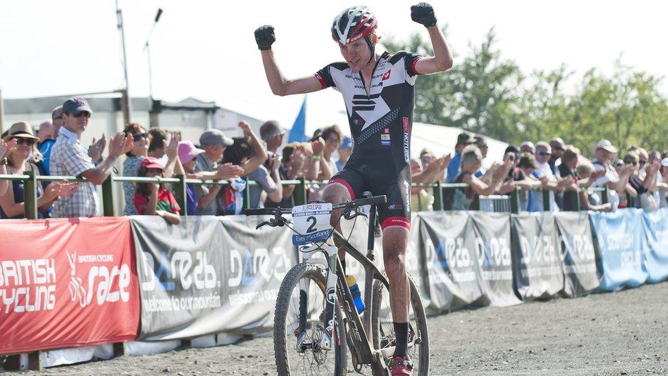 Manchester-based Grant Ferguson, a medal prospect for Scotland in the Commonwealth Games in 2014, takes the applause of the spectators as he wins the senior men's race in 1 hour 42 minutes and 43 seconds. Oliver Beckingsale and David Fletcher were second and third respectively