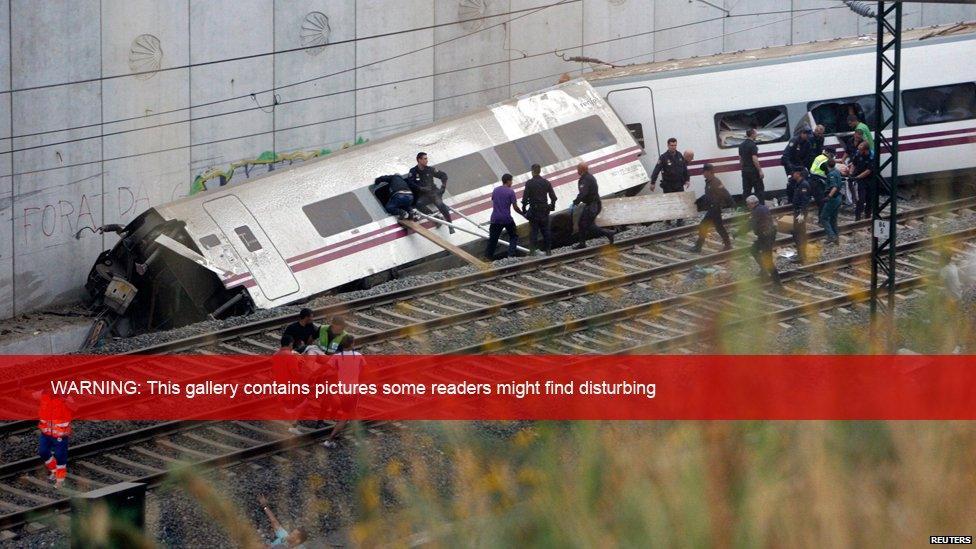 Rescue workers try to reach passengers trapped in the derailed train. 24 July 2013