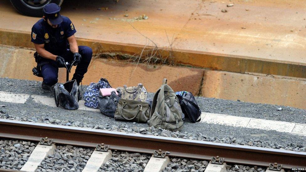 Policeman checking bags by the track