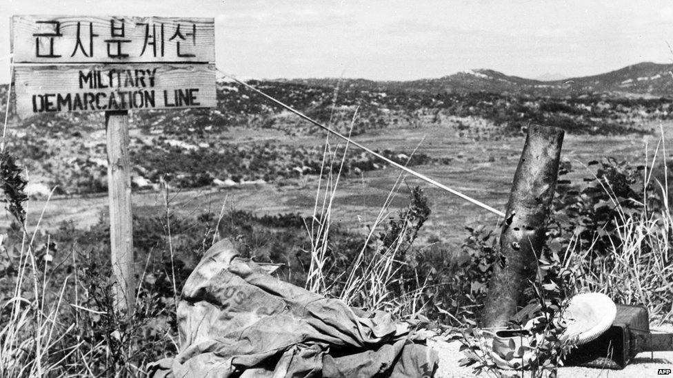 Undated file photo taken of the demarcation line at the 38th parallel between North and South Korea with side by side an American jacket and a pair of Chinese shoes.