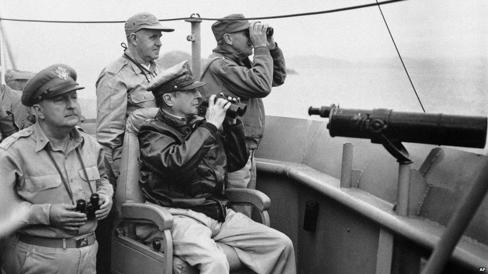 General Douglas MacArthur, seated, and members of his staff view pre landing bombardment and air strikes from the flag bridge of the USS Mt McKinley in Korean waters off Inchon, as US forces begin their offensive in that section 1950