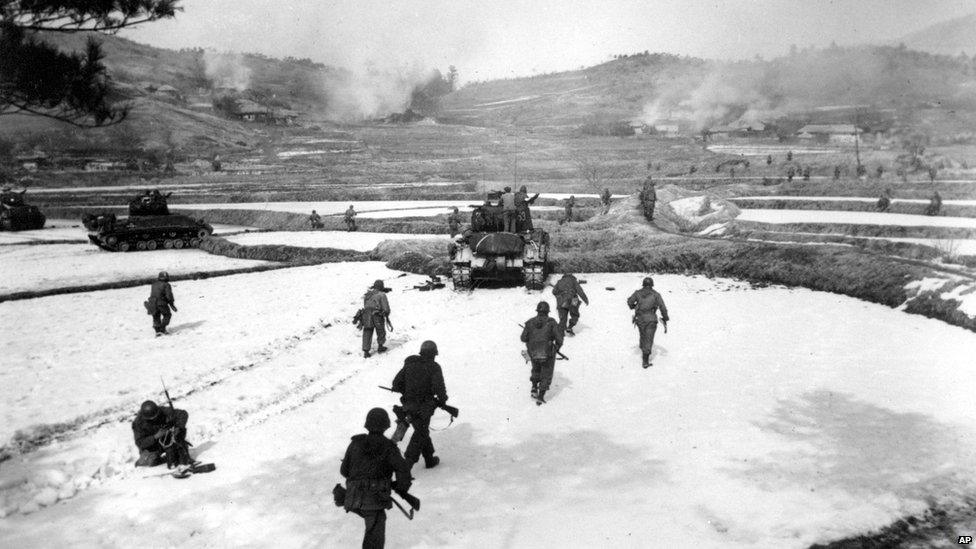 US First Cavalry Division infantrymen, supported by the 24th Division tanks, move out for an assault on an enemy-held hill in South Korea 18 February 1951