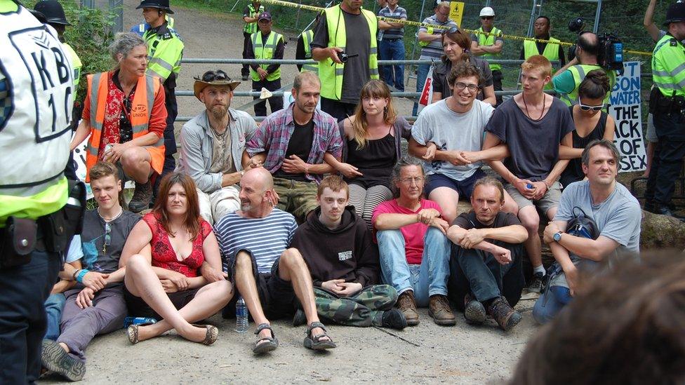 Group of protesters in front of gate