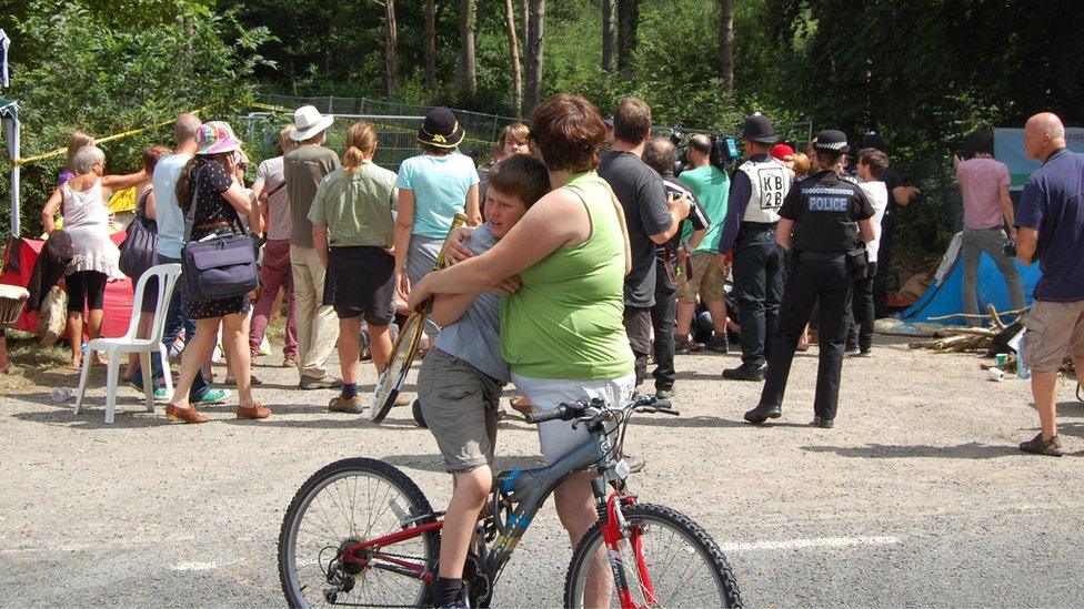 Mother and child in front of protest