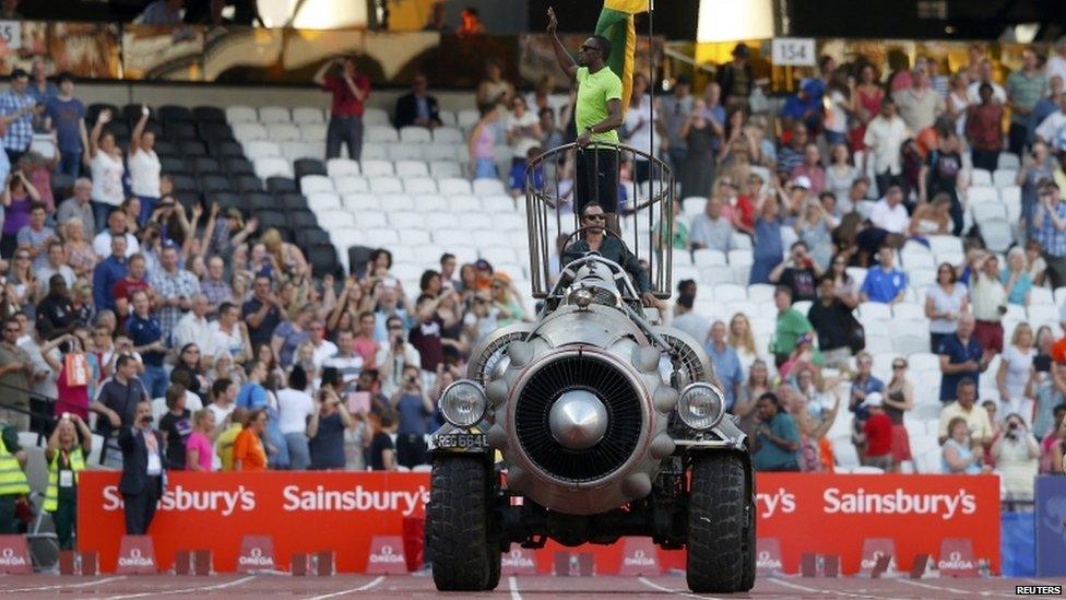 Usain Bolt being driven around the stadium on a rocket