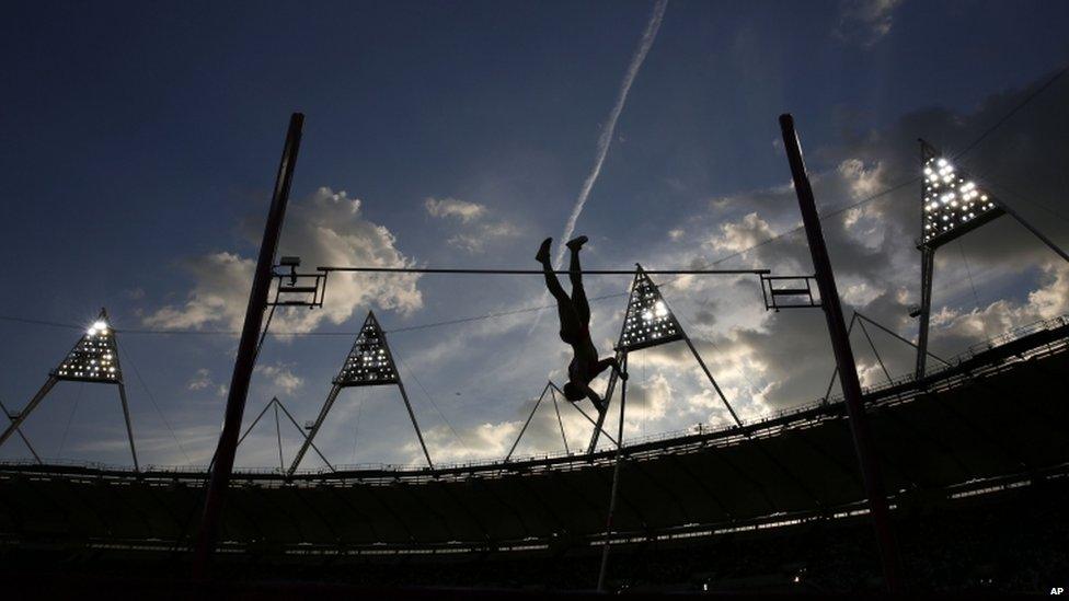 German pole-vaulter Silke Spiegelburg silhouetted against the dusk sky