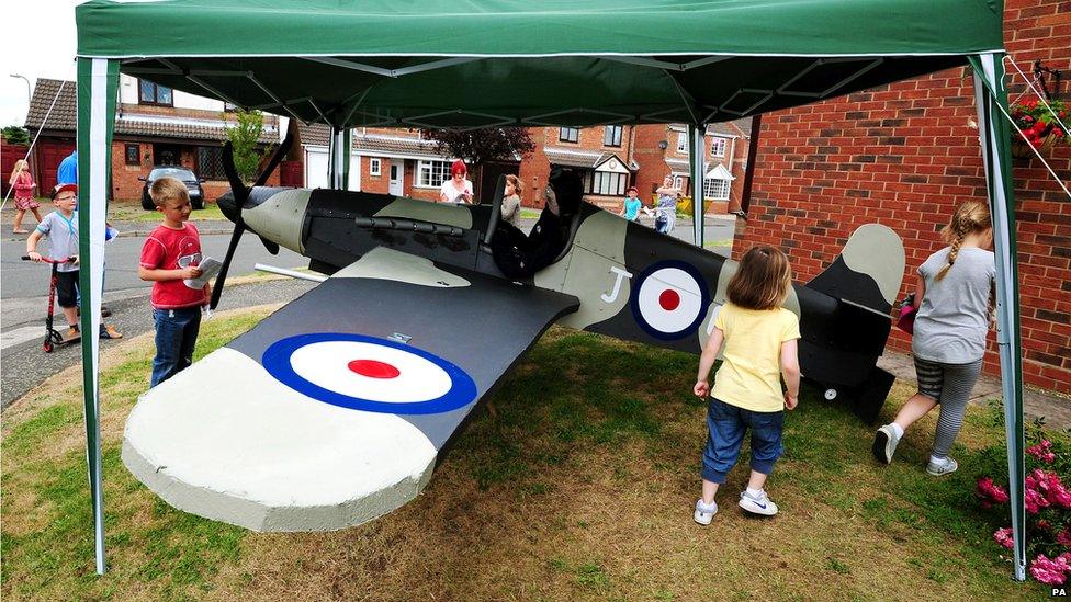 A scarecrow in a military style plane.