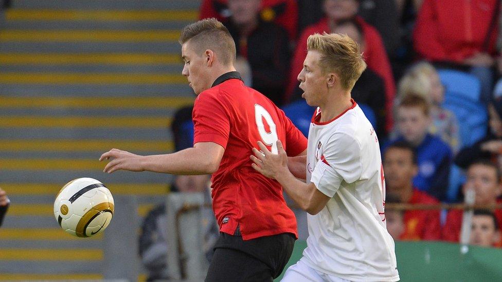 Manchester United's Ruairi Croskery holds the ball up as Matthew Young of County Tyrone attempts to gain possession