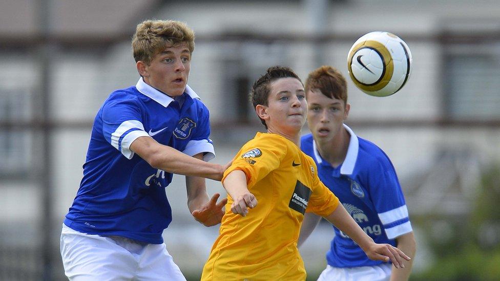 Everton's James Yates and County Antrim's Ryan Caulfield vie for possession during the Junior decider