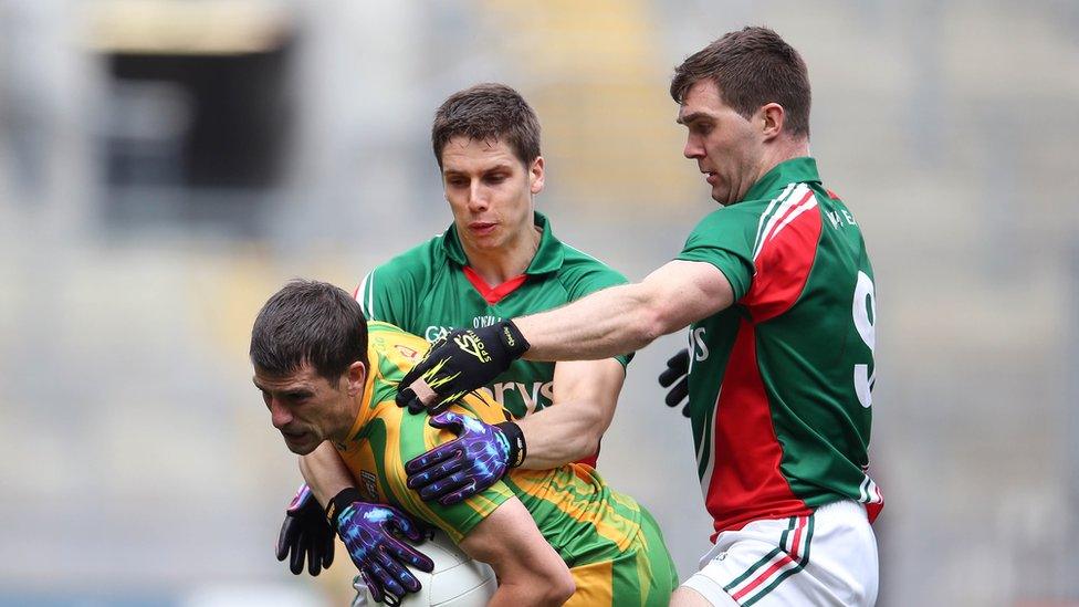 Mayo players Lee Keegan and Seamus O'Shea tackle Paddy McGrath