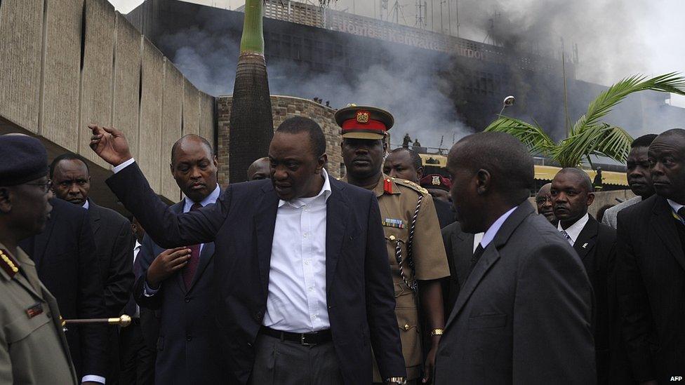 Kenya's President Uhuru Kenyatta visits the Jomo Kenyatta International Airport after a fire burnt a large section of the airport in Nairobi on 7 August 2013.