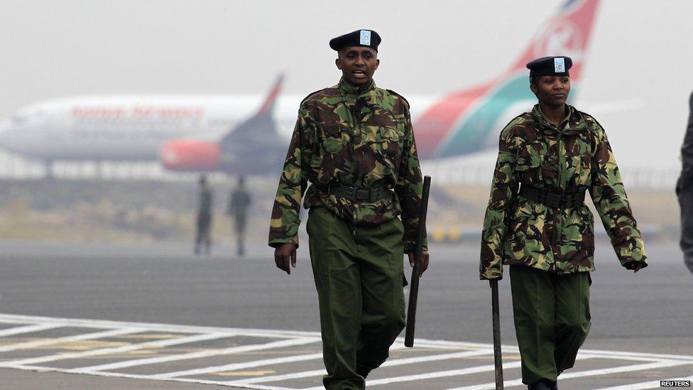 Kenya Airways aircraft stay grounded after a huge fire left all flights suspended at the Jomo Kenyatta International Airport, as soldiers patrols the grounds, in Kenya's capital Nairobi 7 August 2013.