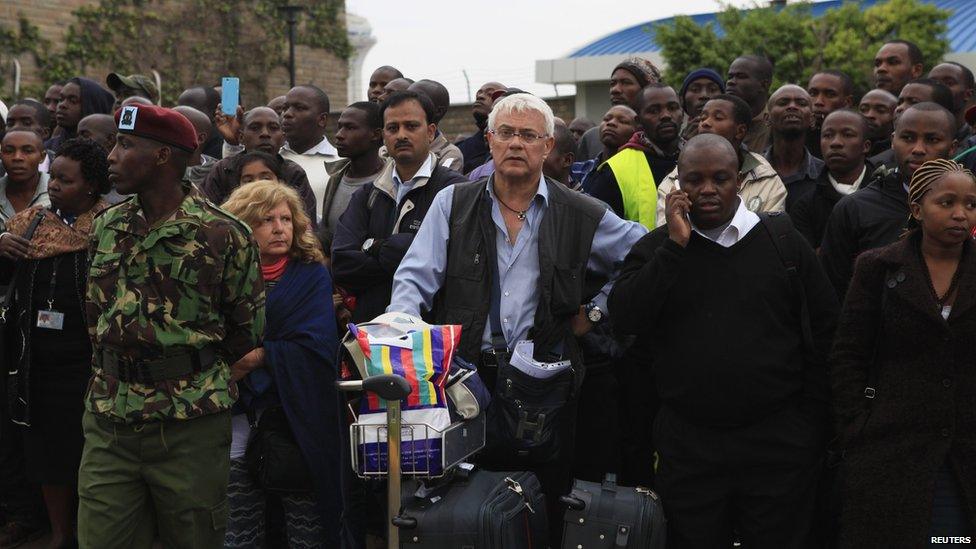 Stranded passengers and onlookers crowd together after a fire disrupted all operations at the Jomo Kenyatta International Airport in Kenya's capital Nairobi 7 August 2013.