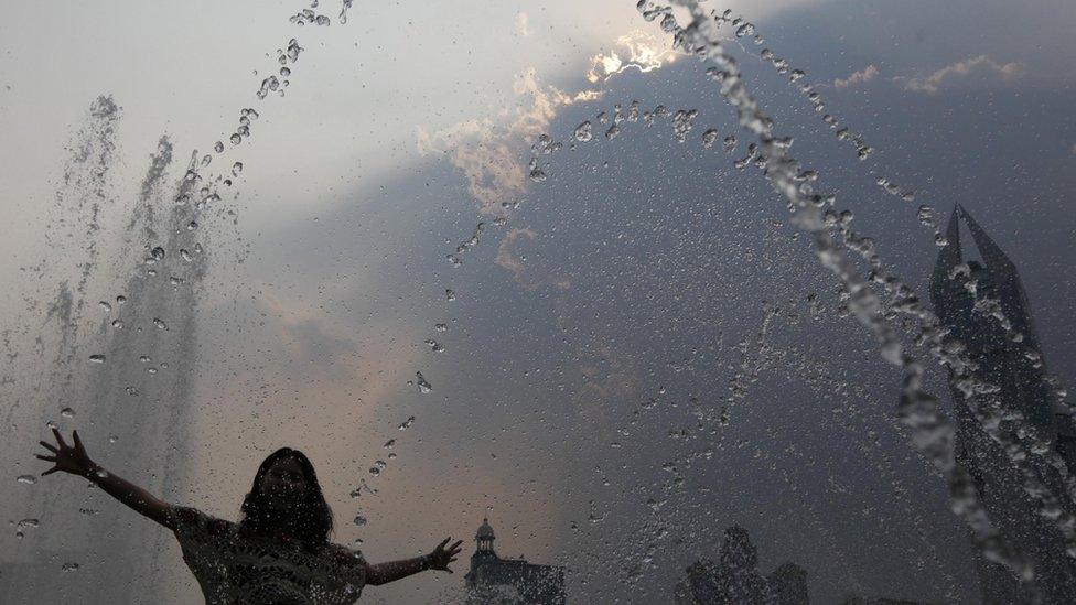 woman plays in fountain
