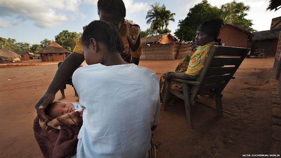 Chimene Kpakanale introducing her new baby to a neighbour in Obo, Central African Republic