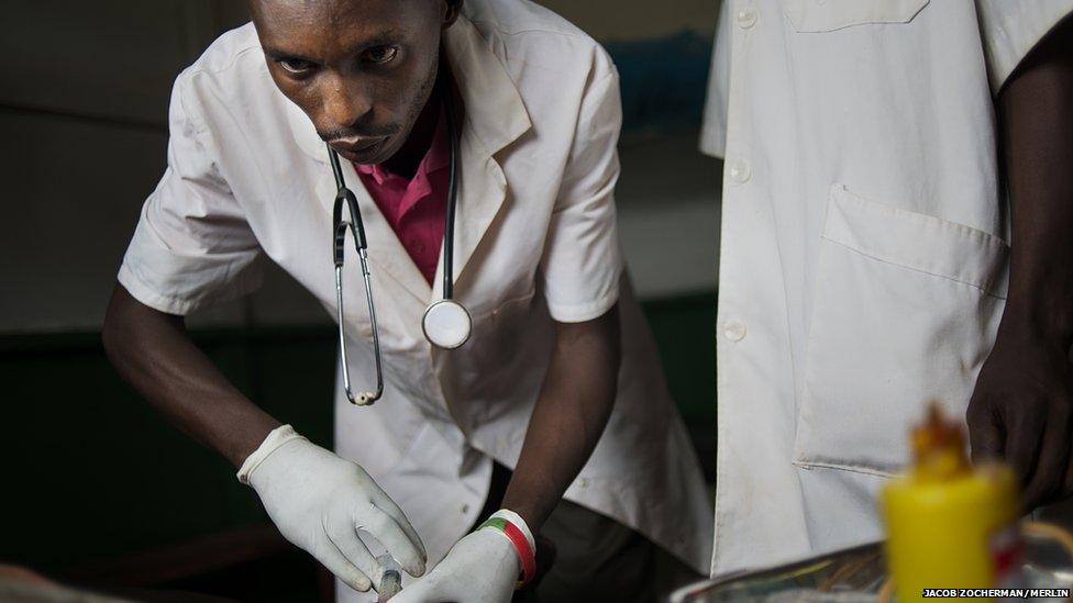 Nurse Anatole Nzu injecting a patient at the Merlin-supported hospital in Batalimo refugee camp, Central African Republic