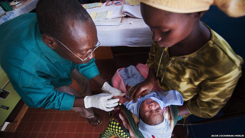 A nurse injects Chimene Kpakanale with her new baby at a Merlin-supported hospital in Obo, Central African Republic